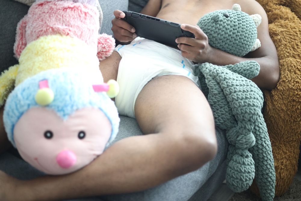 Me wearing just a Northshore Megamax while hold a switch and being surrounded by various stuffed animals.