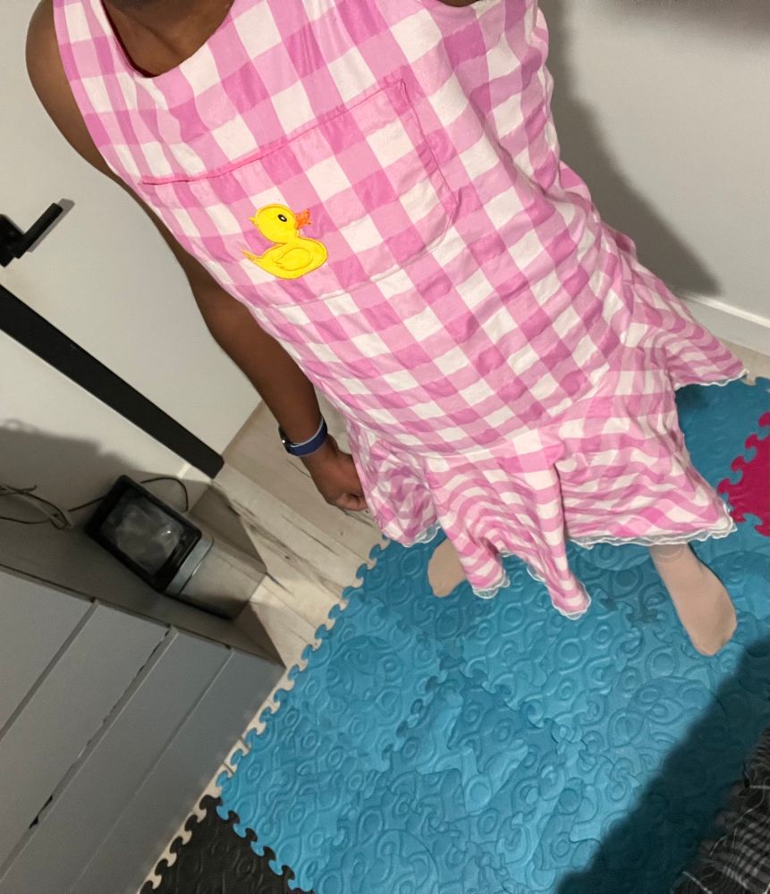 Me wherein a checkered pink and white dress with a duck chest pocket. 