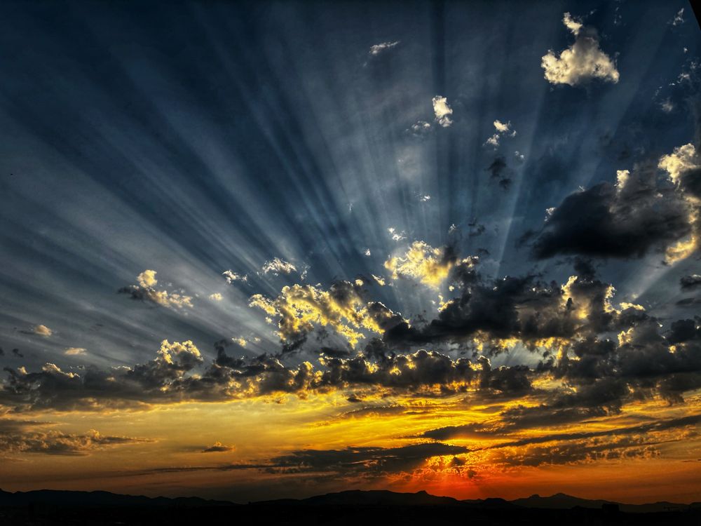 This morning dazzled us with its sunbeams; if only for a few minutes.

The golden sun rising over the distant horizon broke through the grey and white clouds.

The city buildings of Marseille have yet to come out of the darkness.