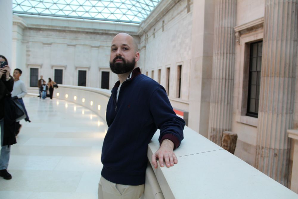 Author Noah Angell standing in the British Museum's Great Court during a walking tour that focuses on the museum's many ghosts. 