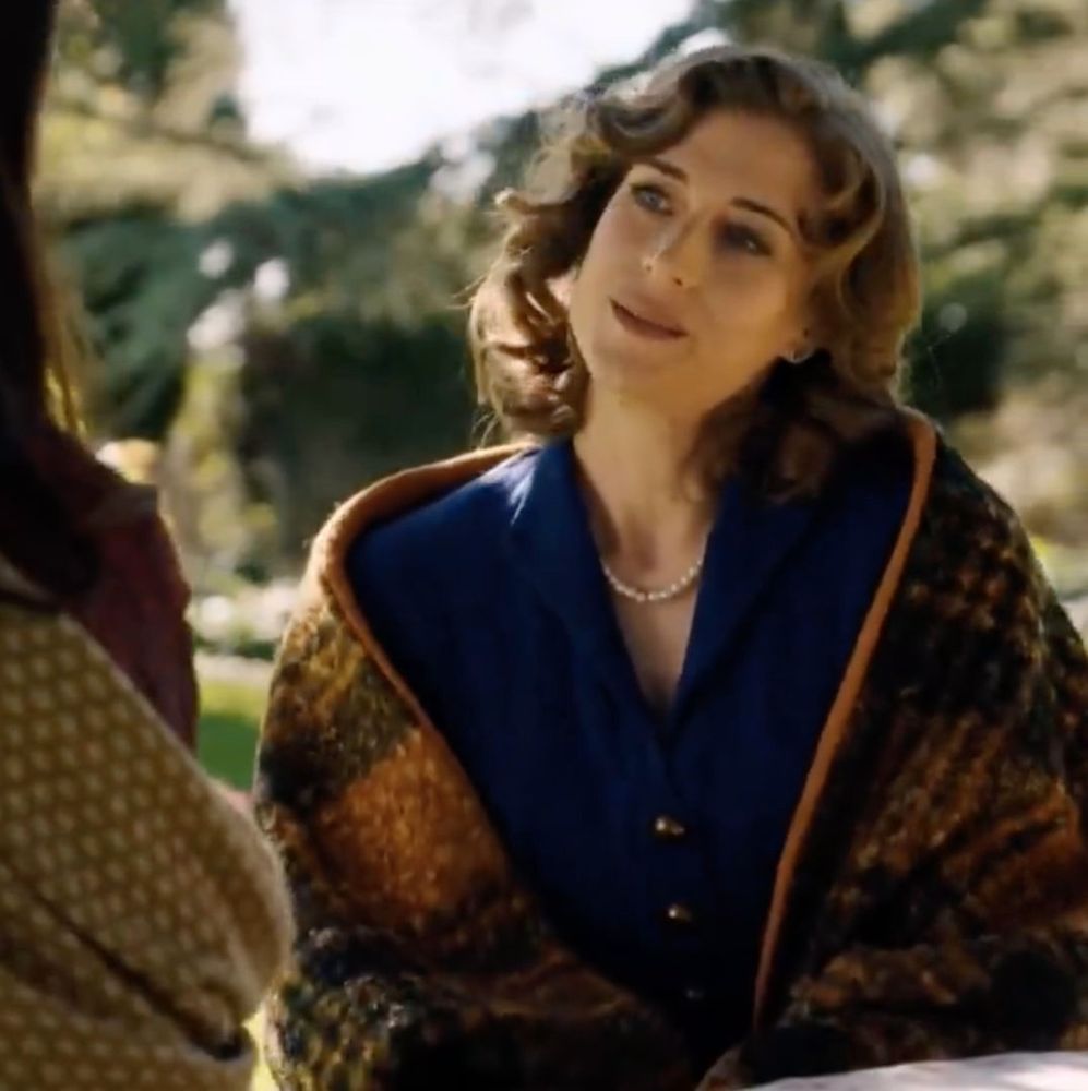 Marta in their garden, looking at Fina.