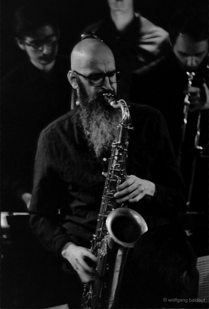 A musician is shown playing a saxophone on stage. The scene is lit with stage lights, creating a dynamic and engaging visual.

The soulful breath of the saxophone fills the air, a musician lost in melody, weaving magic through sound. A moment of pure musical artistry.
