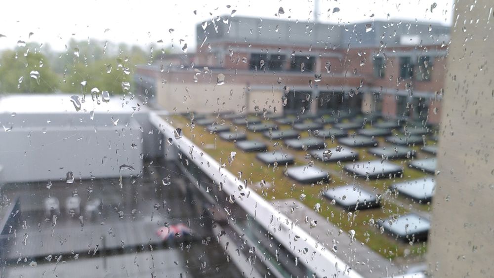 Window with raindrops, in the back parts of the Nikhef building from the top.