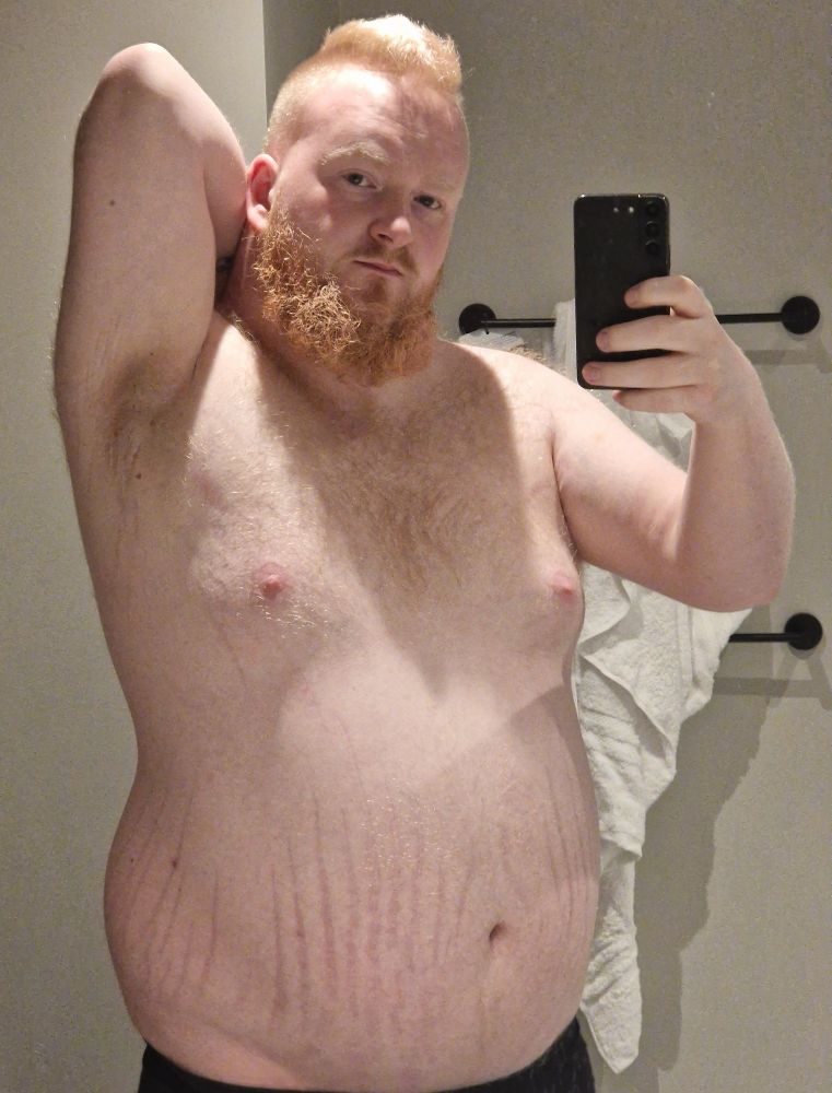 Topless mirror selfie in hotel bathroom