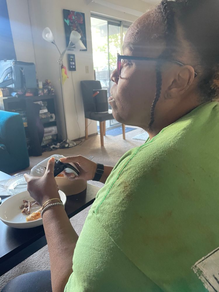 My mom holding a PlayStation controller 