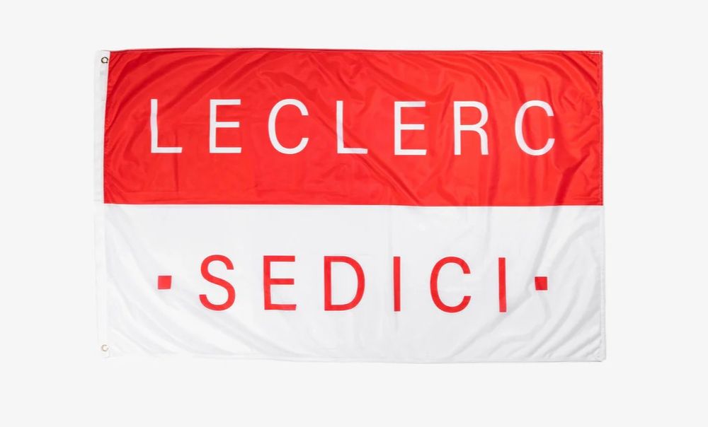 A crunchy looking PNG of the flag of Monaco printed onto a polyester sheet with "LECLERC" printed in white text onto the red band and "•SEDICI•" printed in red text onto the white band. 