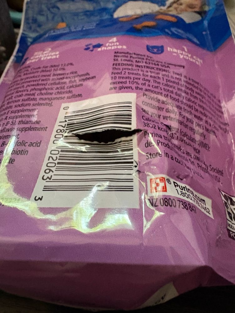 The back of a bag of whisker licking treats, gnawed upon and ripped open by a master thief. 
