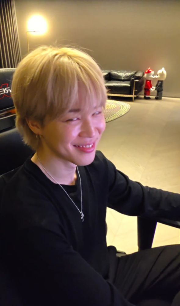 Screenshot from the recent Jimin live. He's sitting in his computer chair looking at the camera with the sneakiest little smirk on his face. Getting away with murder cause he can.