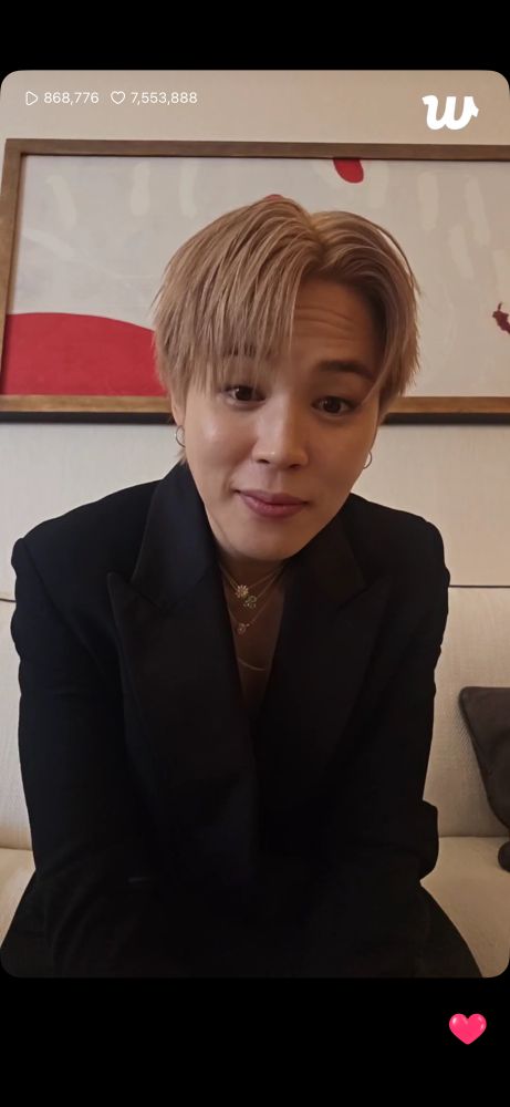 Jimin leaning forward smiling with his eyebrows up
