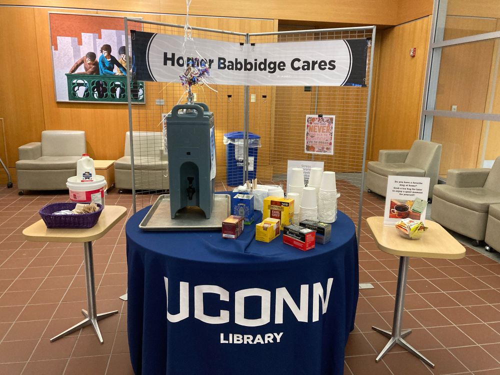 Table with the UConn Library table cloth and tea on it