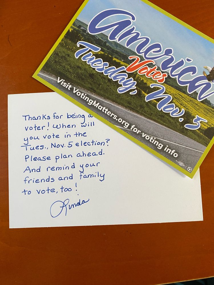 “America votes Tuesday, Nov. 5” postcard showing a blue sky, green fields, and a bald eagle.