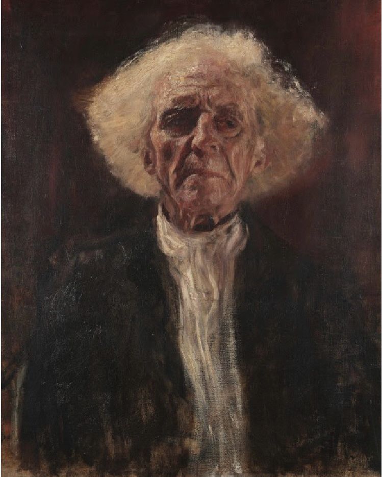 A thin, elderly man with medium length curly white hair sots facing the viewer. He is wearing a white shirt and a dark jacket. His eyes seem to drift away, as he sits alone with his thoughts.