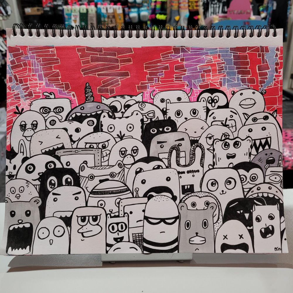 Doodles of a bunch of little monsters in black and white