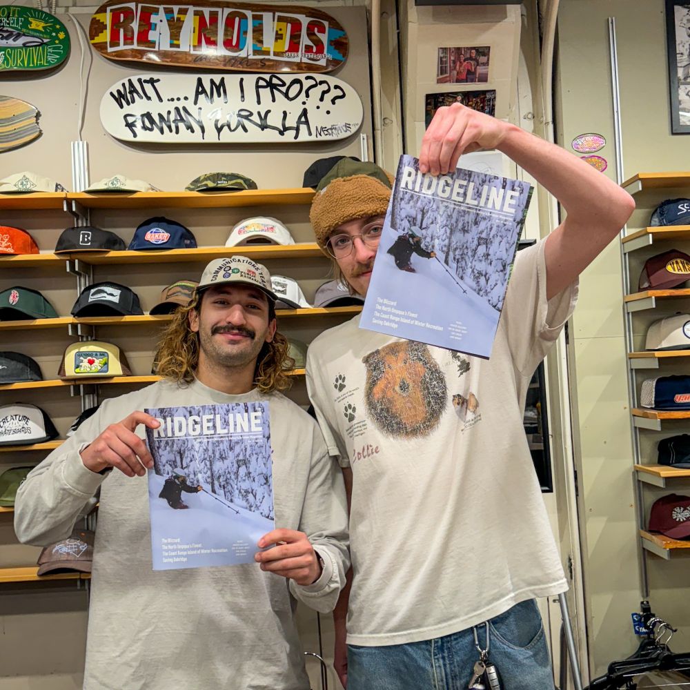 Two people holding copies of Ridgeline Magazine at Tactics Board Shop in Eugene, Oregon.