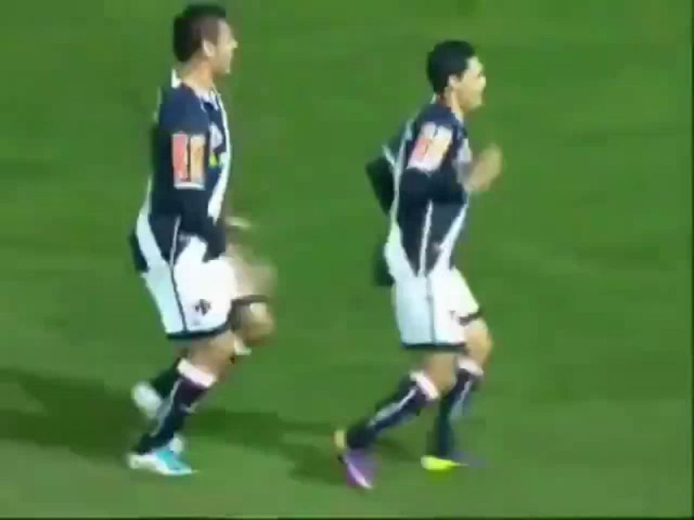 a group of soccer players are running on a field in front of a sign that says ' coca cola '