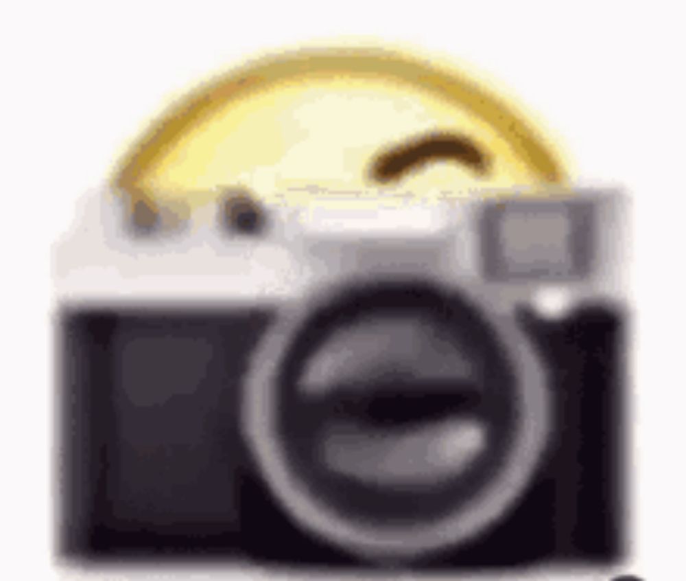 a close up of a camera with a smiley face on top of it .