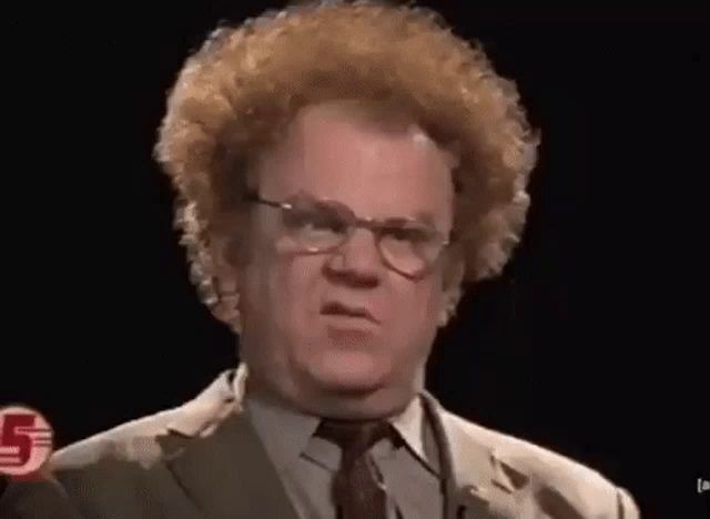 a man with curly red hair and glasses is making a funny face .