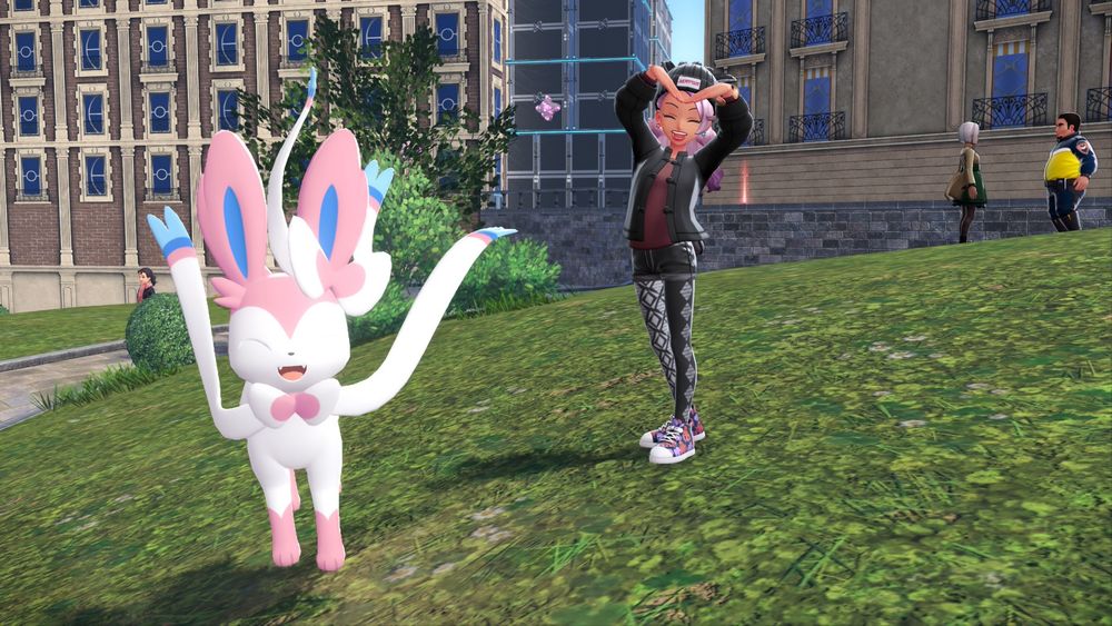 Player character makes a heart over their head with their arms and a giant Sylveon smiles next to her 