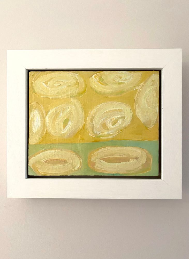 Bright yellow, cream and pale green small abstract oil painting, by Glasgow-based award-winning artist Sarah Kudirka, in a wide white-painted wood frame. Hanging on a subtle/neutral farrowandball painted period interior wall.