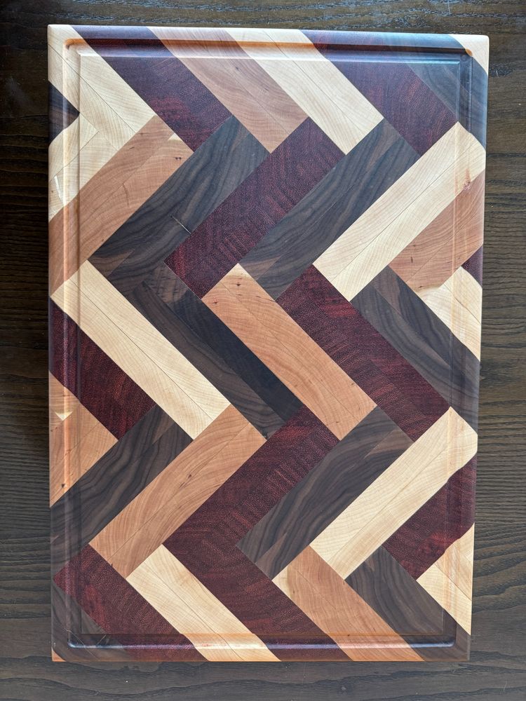 Wood cutting board with chevron pattern.