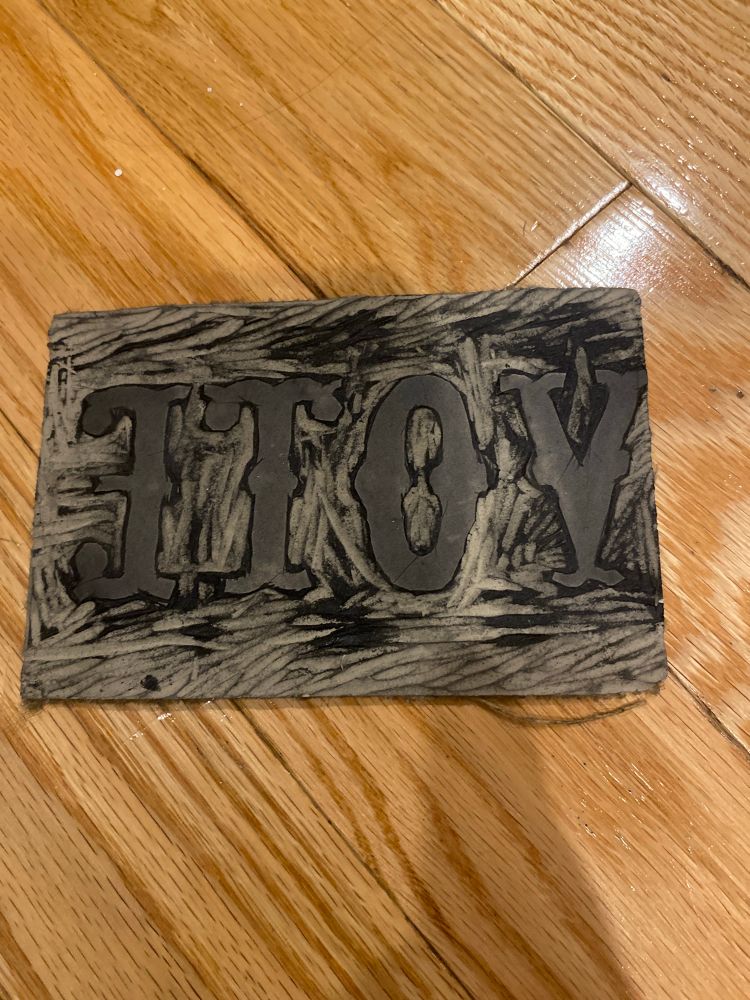 Linocut with the letters spelling out VOTE in mirror image