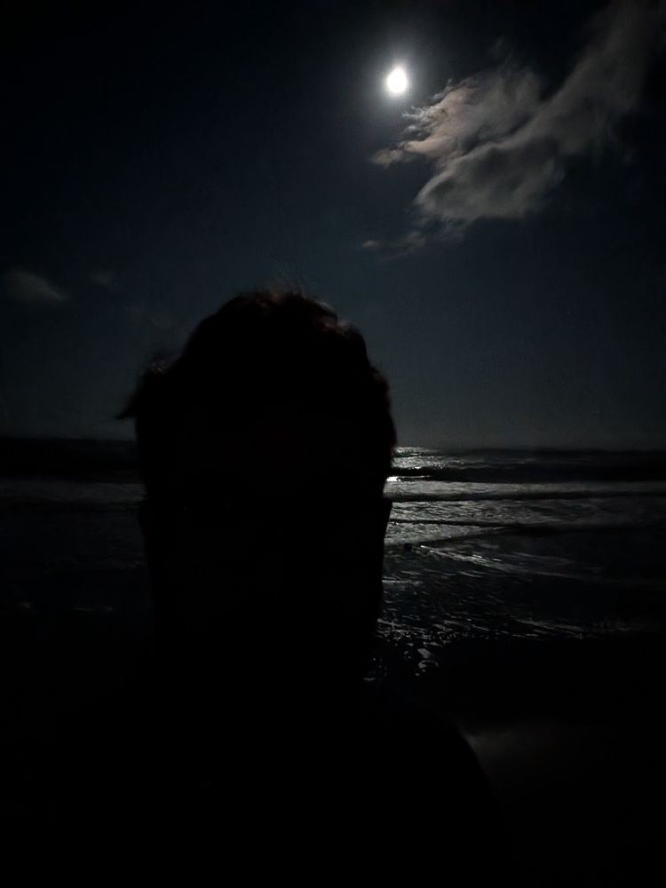 Me taking a selfie on the beach at night 