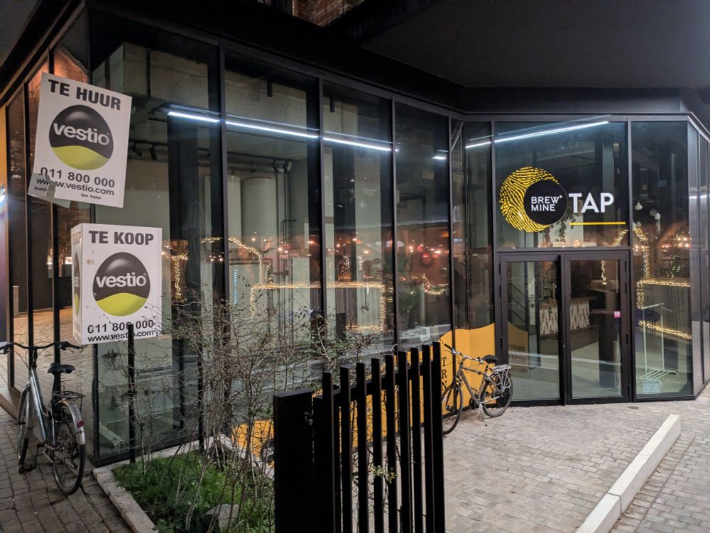 Brewery Mine Hasselt is closed and up for sale. The exterior is large glass doors and panels 