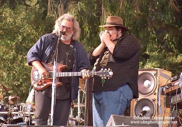  "This show, billed as "A benefit for laughter, love, and music", served to memorialize the band's personal friend and promoter extraordinaire, Bill Graham. Graham, who was killed 9 days earlier when his helicopter collided with a power line tower during bad weather, had been instrumental in promoting the Dead for over two decades. 
     "This Sunday morning performance, which features a star studded line up of musicians, actors, and personalities including Bobby McFerrin, Jackson Browne, Carlos Santana, Robin Williams, Crosby Stills Nash and Young, Joan Baez and more, began with Graham's oldest son David, speaking briefly of his father's legacy and passion for life, before introducing the band to start the show. Thousands of beach balls were batted around the crowd even as the first notes of the opening number, Hell In A Bucket, rang out. A beautifully played China>Rider followed next, coming in for nearly 12 minutes. A short tuning break then gave way to a white hot Wang Dang Doodle featuring Blues Traveler's John Popper, channeling his inner Pigpen, on the harmonica. Another short tuning break follows, with Weir announcing, "Ok, we got another guest real quick", before Creedence Clearwater Revival's John Fogerty takes over lead vocals for the band's first and only offerings of the CCR hits, Born On The Bayou, Green River, Bad Moon Rising, and Proud Mary. 
     "Jerry and the boys really hit their stride with a long jam that opens with Truckin' followed by The Other One>Wharf Rat>a Sunshine Daydream that completes the Sugar Magnolia opener from Oakland Coliseum on the 27th. 
     "This already rockin' show is made that much sweeter with the double encore of Forever Young and Touch Of Grey. This 7 minute Forever Young, the band's first and only offering of the Bob Dylan classic, features Neil Young on guitar and lead vocals, and the Touch Of Grey that closes the show may just be one of their best."
~CW, GDH 