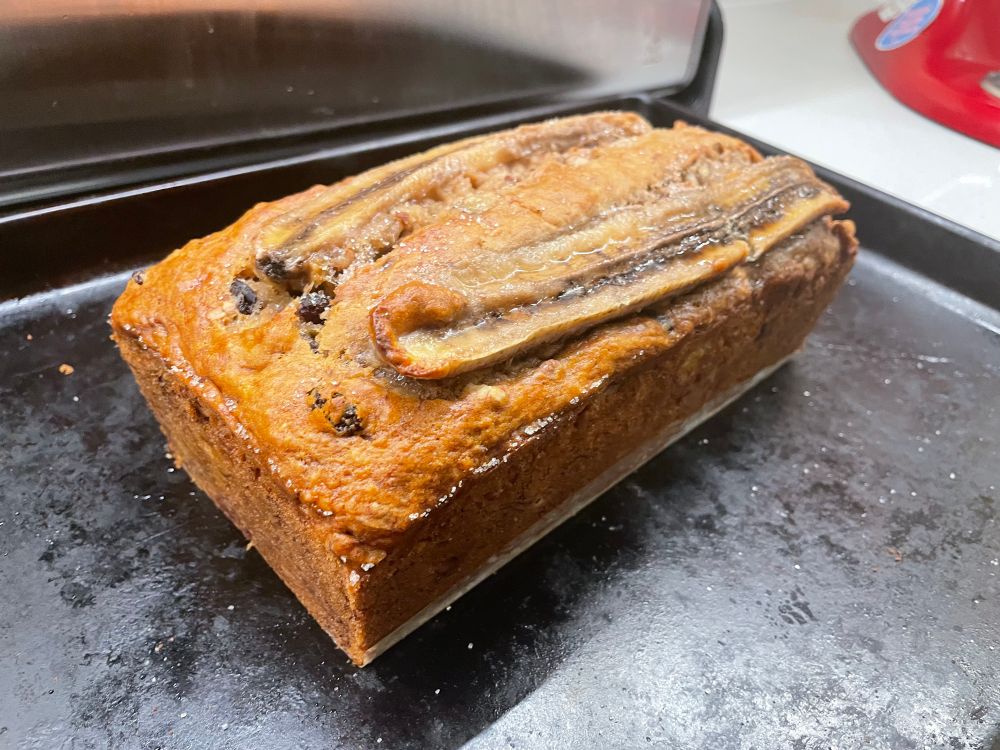 side view of loaf of banana bread on a baking tray