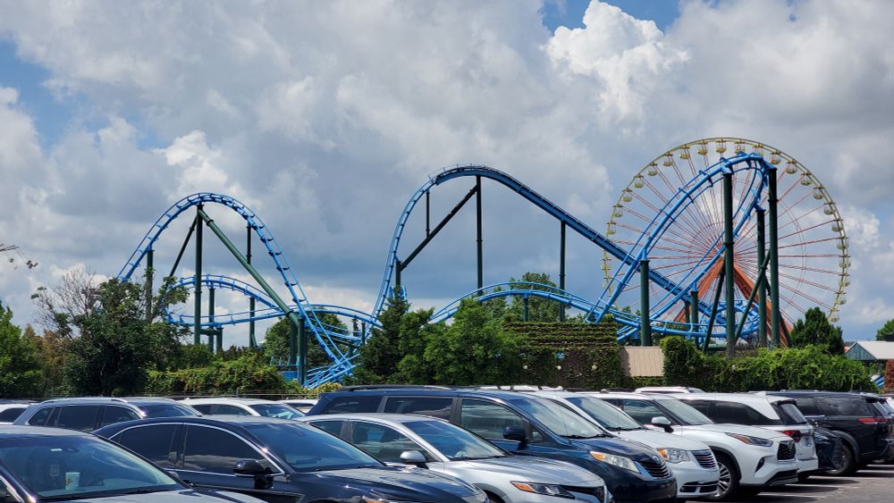 Lightning Run roller coaster at Kentucky Kingdom amusement park with the Giant Wheel observation wheel behind it. 