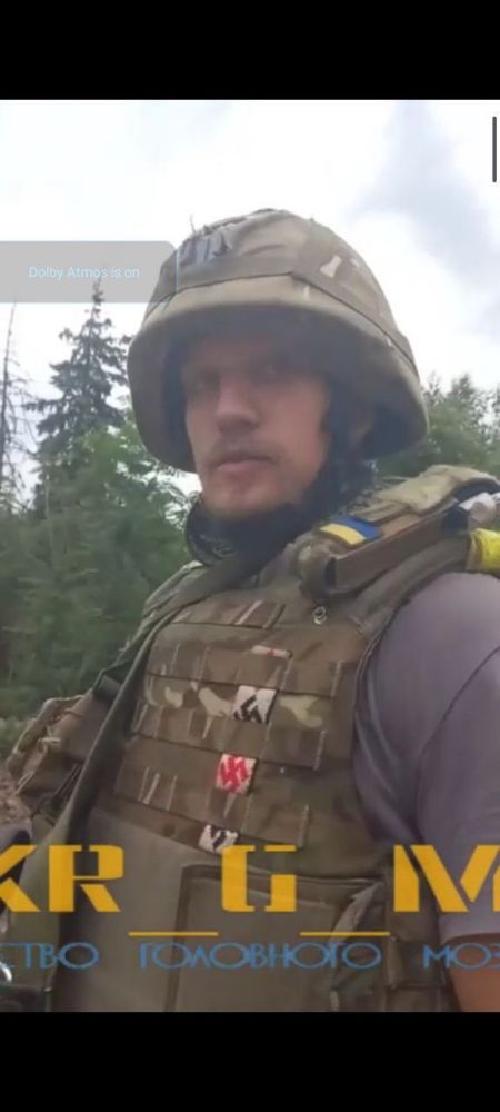 A soldier is depicted in military uniform with a Ukrainian flag patch and multiple swastikas.