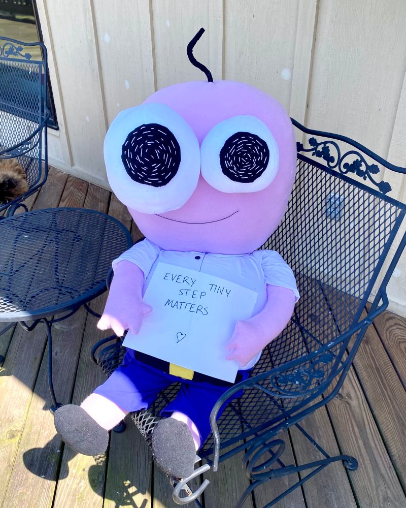 pim from smiling friends smiling and holding a sign that says “every tiny step matters”