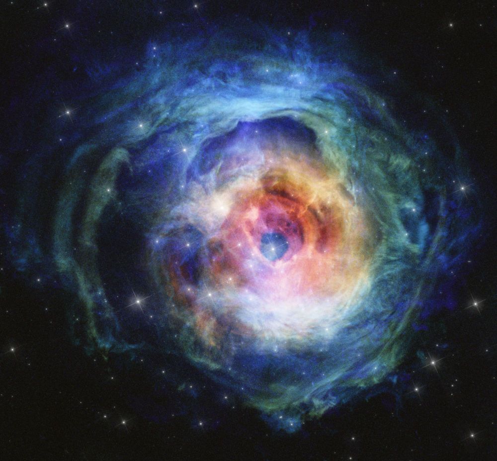 A breathtaking image of V838 Monocerotis, a red giant star that mysteriously brightened dramatically in 2002. The nebula surrounding the star is a result of this outburst, showcasing a complex interplay of colors and textures as the star's light interacts with the surrounding gas and dust.