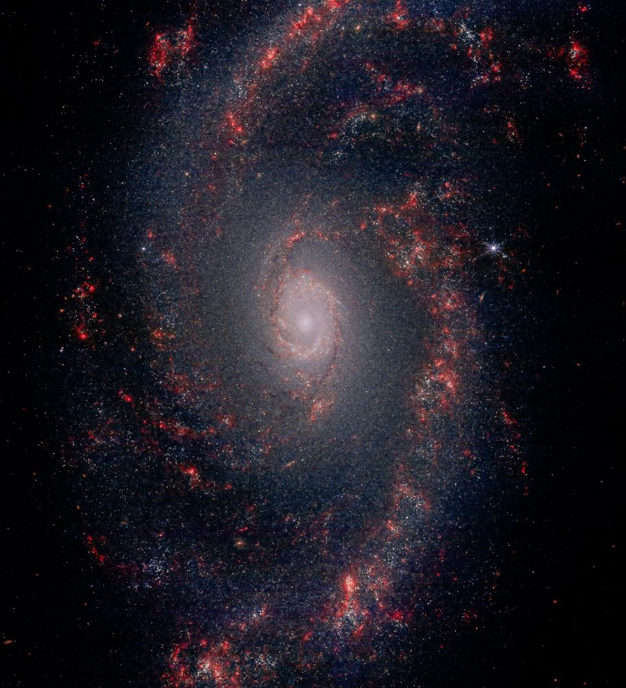 This image shows NGC 5248, a spiral galaxy located about 50 million light-years away in the constellation Hydra. The galaxy is seen face-on, revealing its bright central core and swirling spiral arms. The image was captured by the Near-Infrared Camera (NIRCam) instrument on the James Webb Space Telescope.