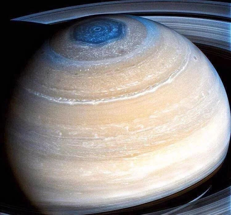 This is the closest image of Saturn ever captured by the Cassini spacecraft. It shows the planet in a majestic and serene light, with its rings in the foreground. The planet's golden hues are highlighted by the sunlight filtering through its upper atmosphere. A notable feature is the intriguing hexagonal storm at the north pole, a unique weather phenomenon in our solar system. The image provides an unparalleled, close-up perspective, inviting viewers to appreciate the intricate details of Saturn's cloud bands and the sheer vastness of its ring system. It is a stunning portrayal of the beauty and complexity of this gas giant, captured from a vantage point closer than any human-made probe has ventured before.