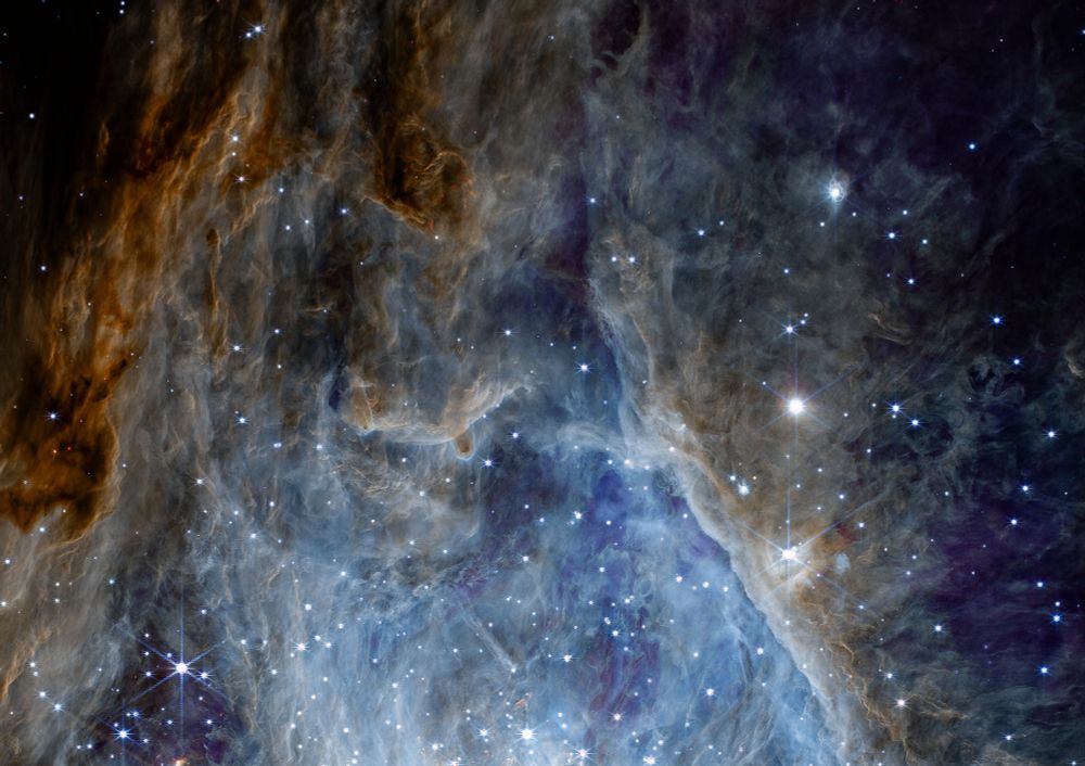 This NIRCam image captures the Orion Nebula in stunning detail, revealing a cosmic tapestry of vibrant hues and celestial structures. The nebula's dense clouds of gas and dust are illuminated by young, energetic stars, creating a breathtaking display of interstellar birth and evolution. The image showcases the intricate interplay of light and matter, highlighting the nebula's intricate filaments, pillars, and cavities, as well as the surrounding star-forming regions. The Orion Nebula, a stellar nursery located approximately 1,344 light-years away, offers a glimpse into the dynamic processes that shape our universe.