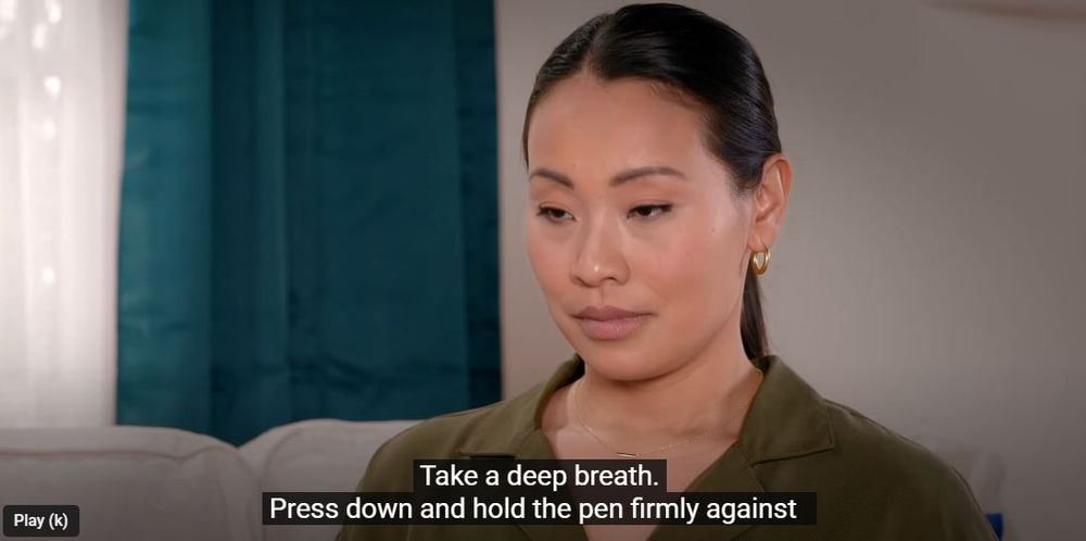 she does not look happy - stoney eyes and a look of absolute lack of emotion, she is about to inject dupixent in her thigh