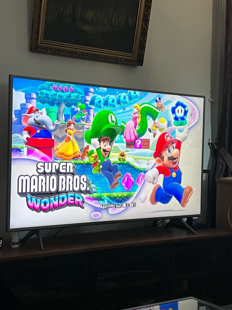 My TV with the Home Screen of the video game “Mario Bros Wonder”