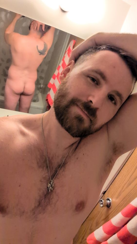 A picture of me fully naked with my arm up wrapped around the backside of my head. I'm the background there is a mirror showing my back/butt