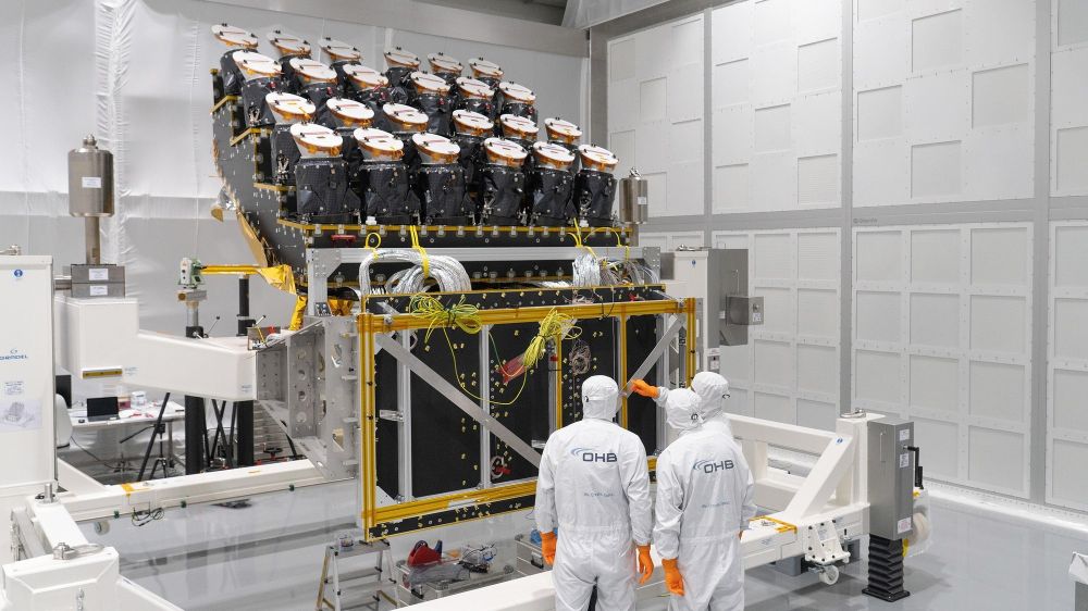 Engineers in a clean room OHB inspect Plato's newly installed 24 cameras on the spacecraft's optical bench.