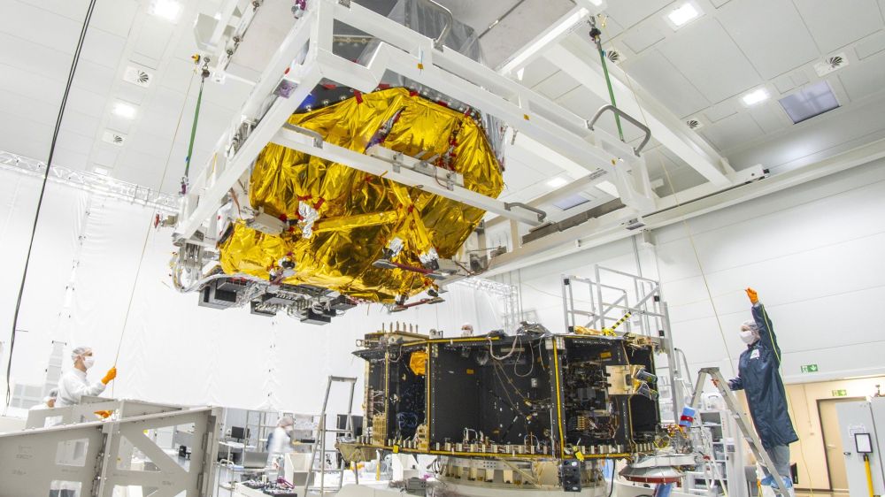 PLATO's 'optical bench' with its 26 cameras being lifted onto the service module of the spacecraft in a clean room.