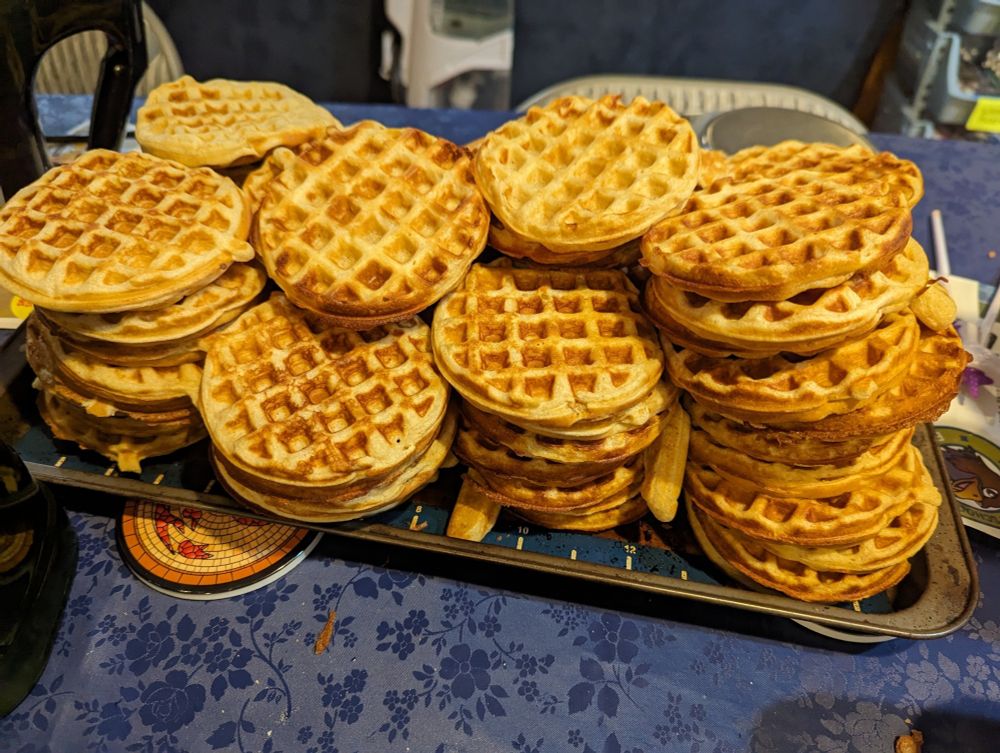 A cookie sheet stacked high with waffles. I didn't count them. Each stack is 8-10 waffles and there are eight stacks, though one is nearly hidden. Call it seventy waffles all together...? Anyway, it's a lot.