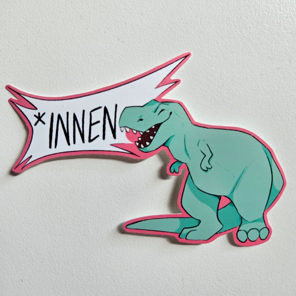 A sticker of a teal t-rex shouting to the left with a speech bubble saying "*innen".