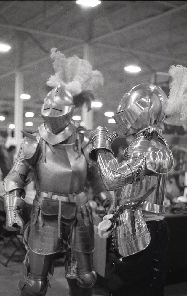 some knights pose for a photo in plate armour