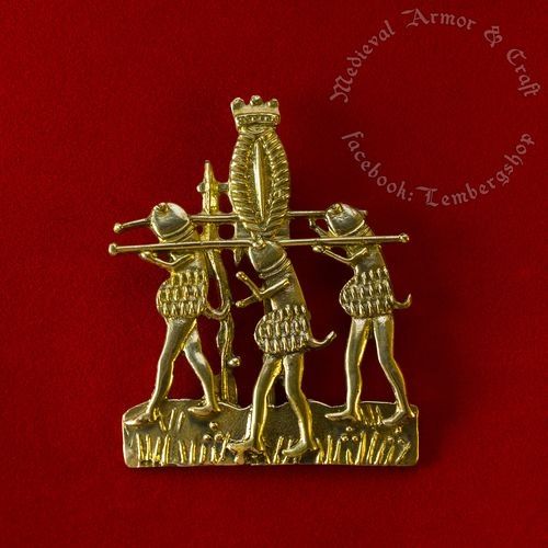 the pilgrim badge that the illustration is based on. three golden phalluses carry a vulva wearing a crown on a pedestal.