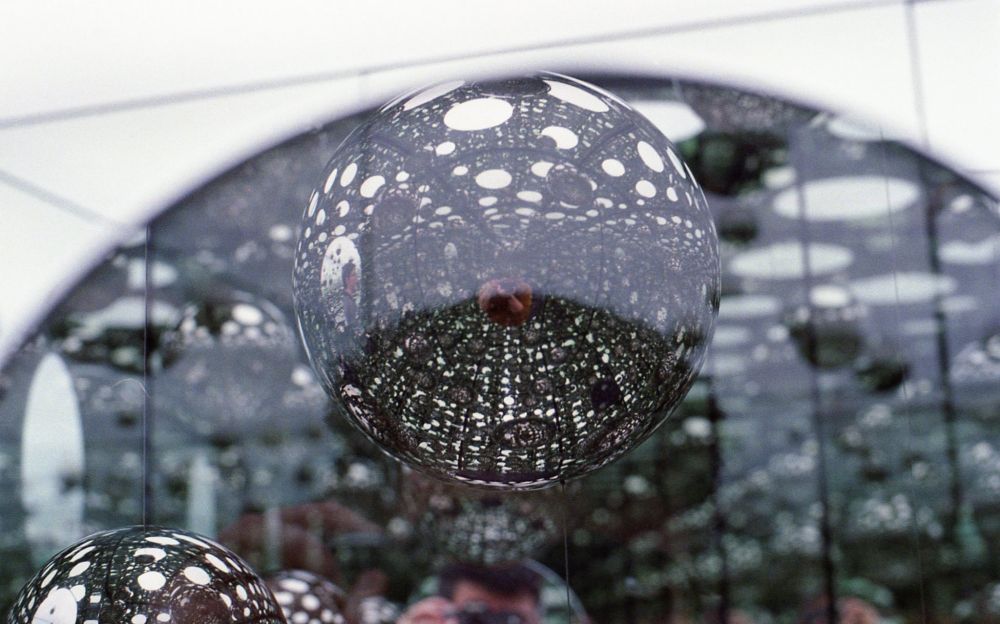 a close up of Yayoi Kusama's Infinity Rooms installation, of the mirrored balls