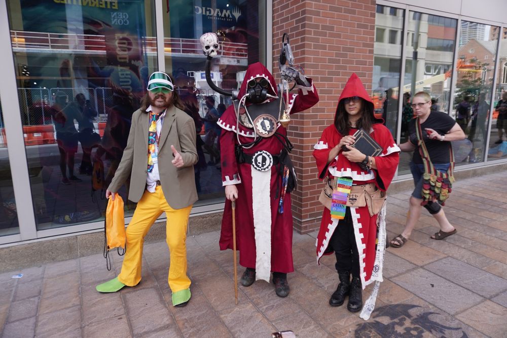 Cosplay of Harry Du Bois standing next to two other tech priests