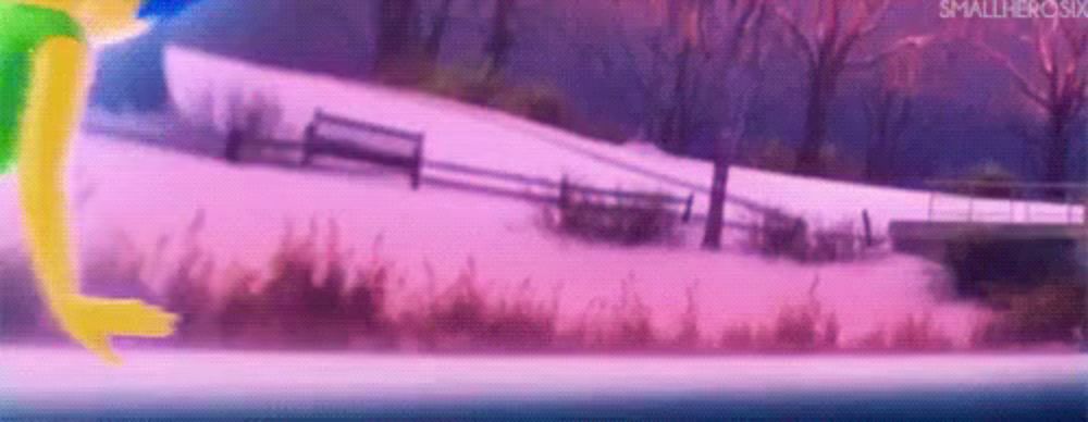 a person is running in the snow in front of a fence and a bridge .