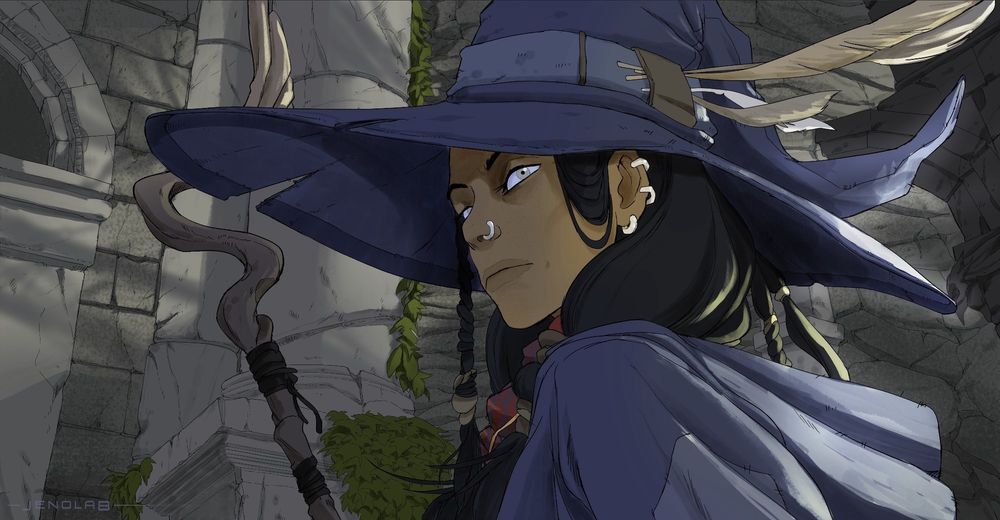 A witch seen in a close-up of her face. She wears blue clothing, a cape, and a hat adorned with owl feathers. She holds a mage staff shaped like an owl's wing. Her skin tone is mixed, her hair is black and long, styled into braids on each side of her face, also decorated with feathers. She gazes off-camera, intrigued and focused, on high alert, in a setting that appears to be in ruins.