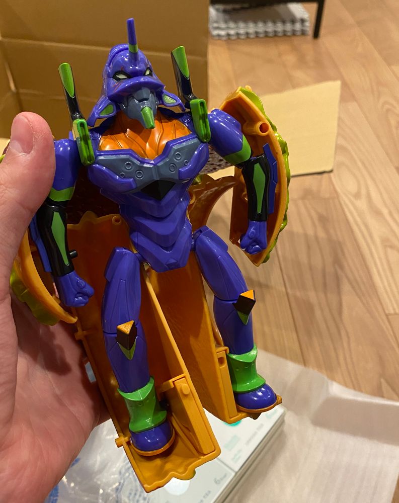 that transforms into a plastic Unit 01 from Evangelion